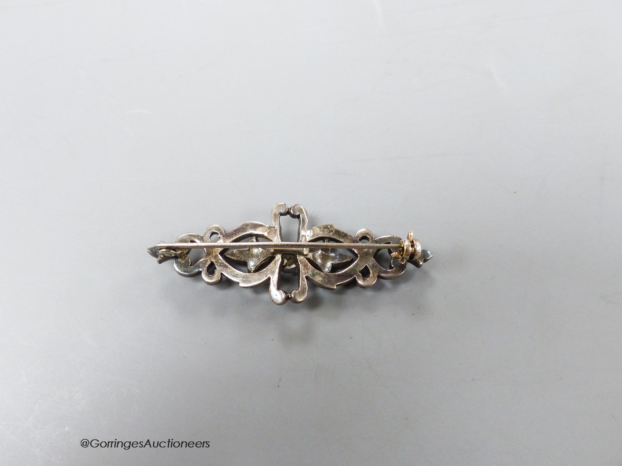 A Victorian white metal (probably silver?) and rose cut diamond encrusted openwork bar brooch, 49mm, gross 6.6 grams.